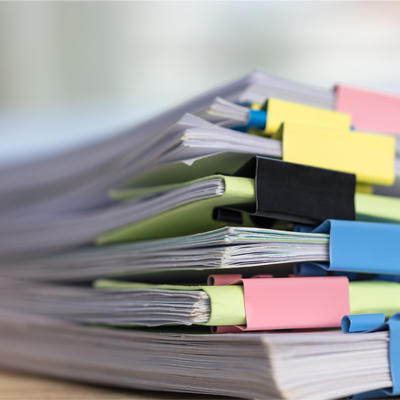 A stack of papers with binder clips